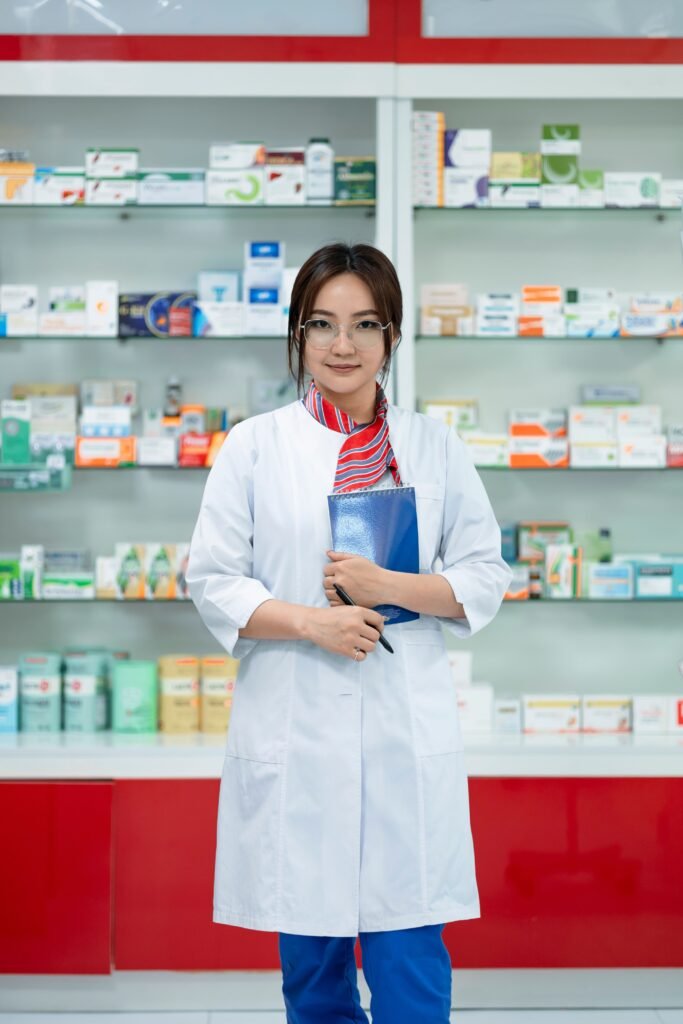 Pharmacy student in a white coat in hospital or clinic, confident but slightly nervous expression First Clinical Rotation