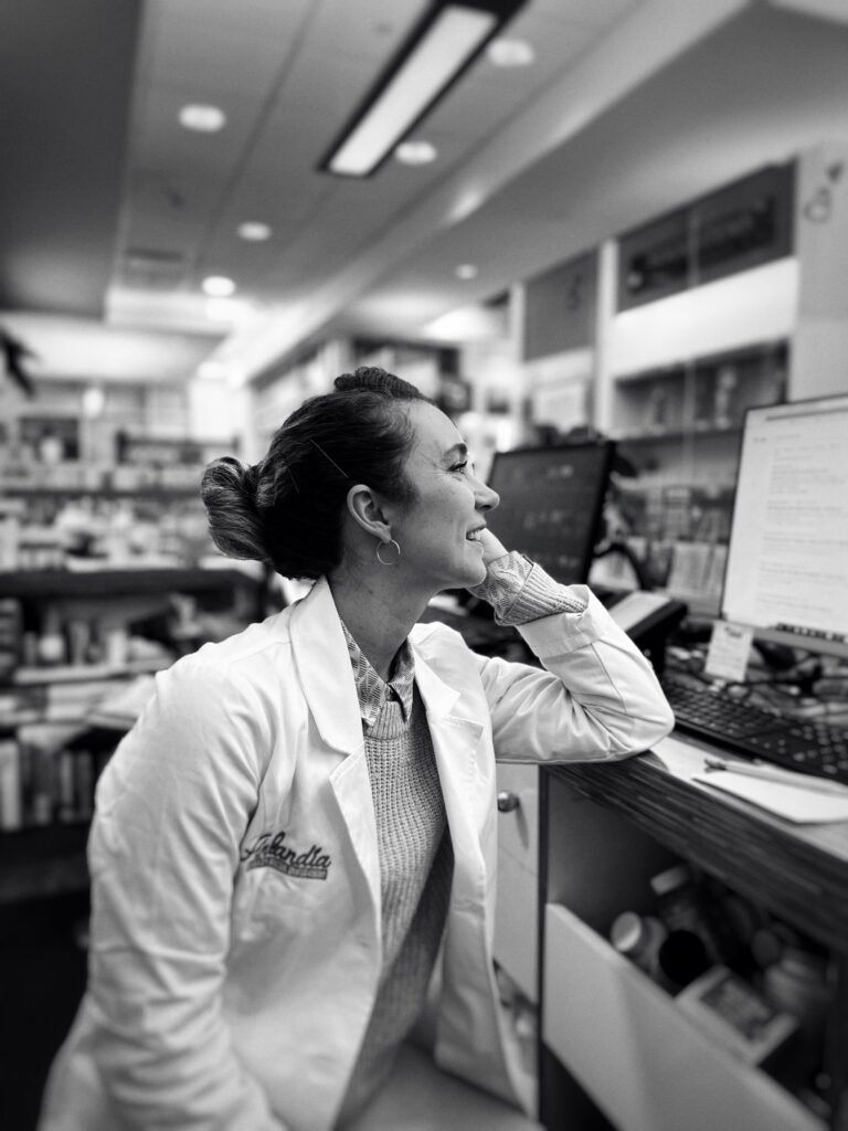 Confident smiling pharmacy student mid-conversation during First Clinical Rotation